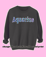 Load image into Gallery viewer, Black astrology sweatshirt with &#39;Aquarius&#39; in bold leopard print lettering, set against a vibrant blue and purple animal print background. Cozy fleece-lined zodiac jumper, perfect for astrology lovers and star sign fashion
