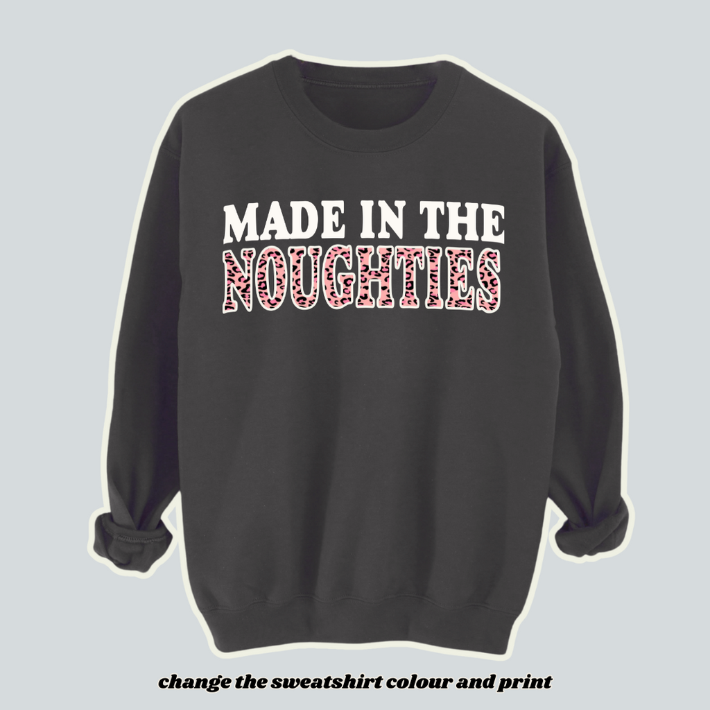 lack "Made in the Noughties" sweatshirt with bold white and pink leopard print lettering, inspired by 00s fashion trends. Customisable Y2K-style jumper for those born in the 2000s, featuring a cosy fleece-lined design. Perfect for nostalgic 00s babies and retro streetwear lovers.